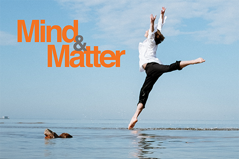 Image of dancer leaping in the air by the sea shore