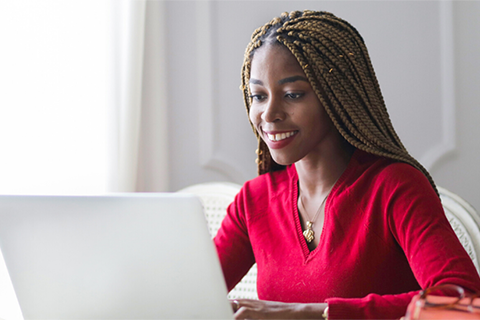 Woman working on her laptop at home.