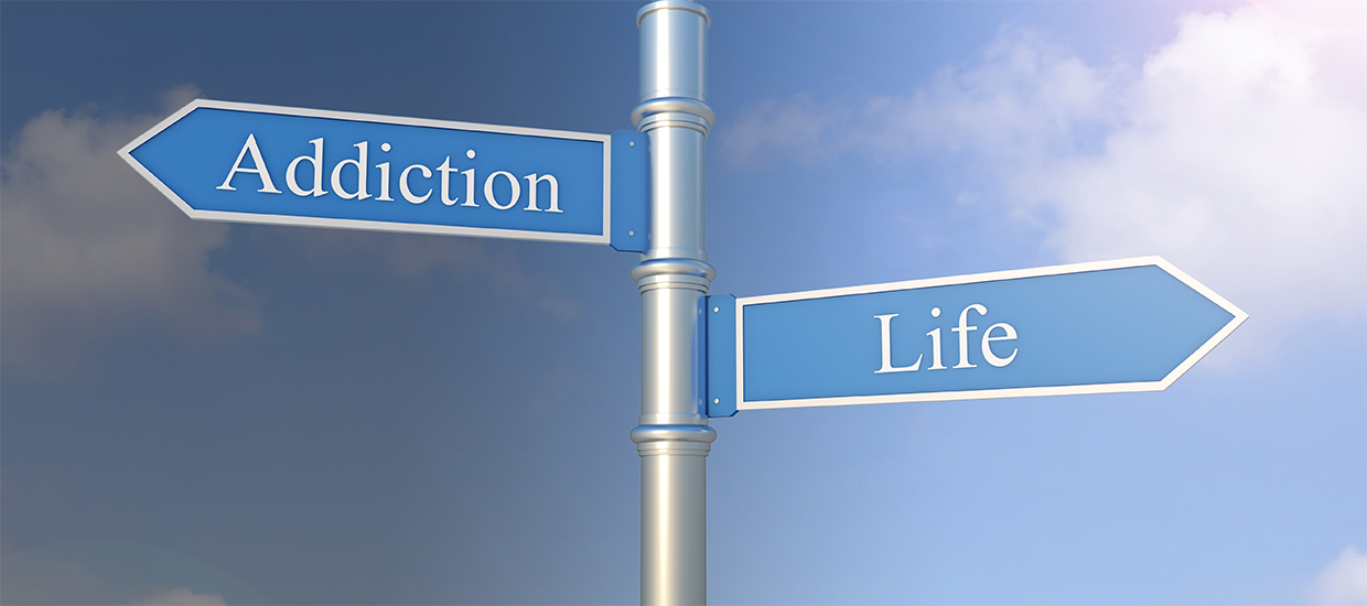 Image of a sign post with two arrows pointing in opposite directions "Addiction" and "Life"