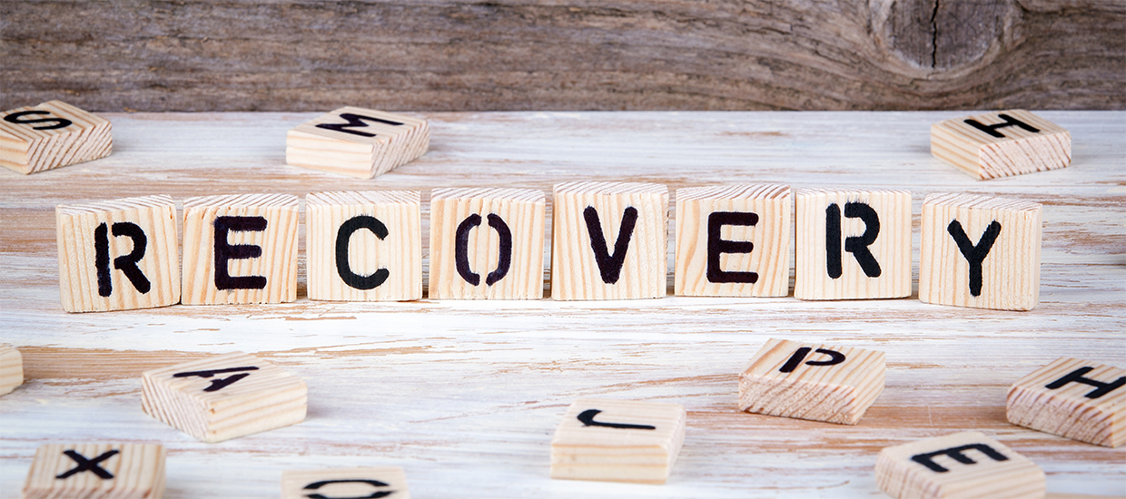 Image of scrabble pieces grouped together to spell the word recovery