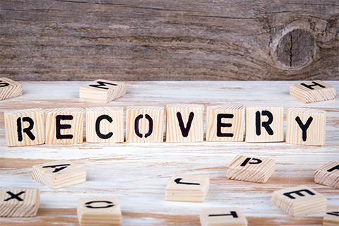 Image of scrabble pieces grouped together to spell the word recovery