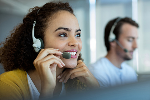 Image of woman answering the telephone in a call center